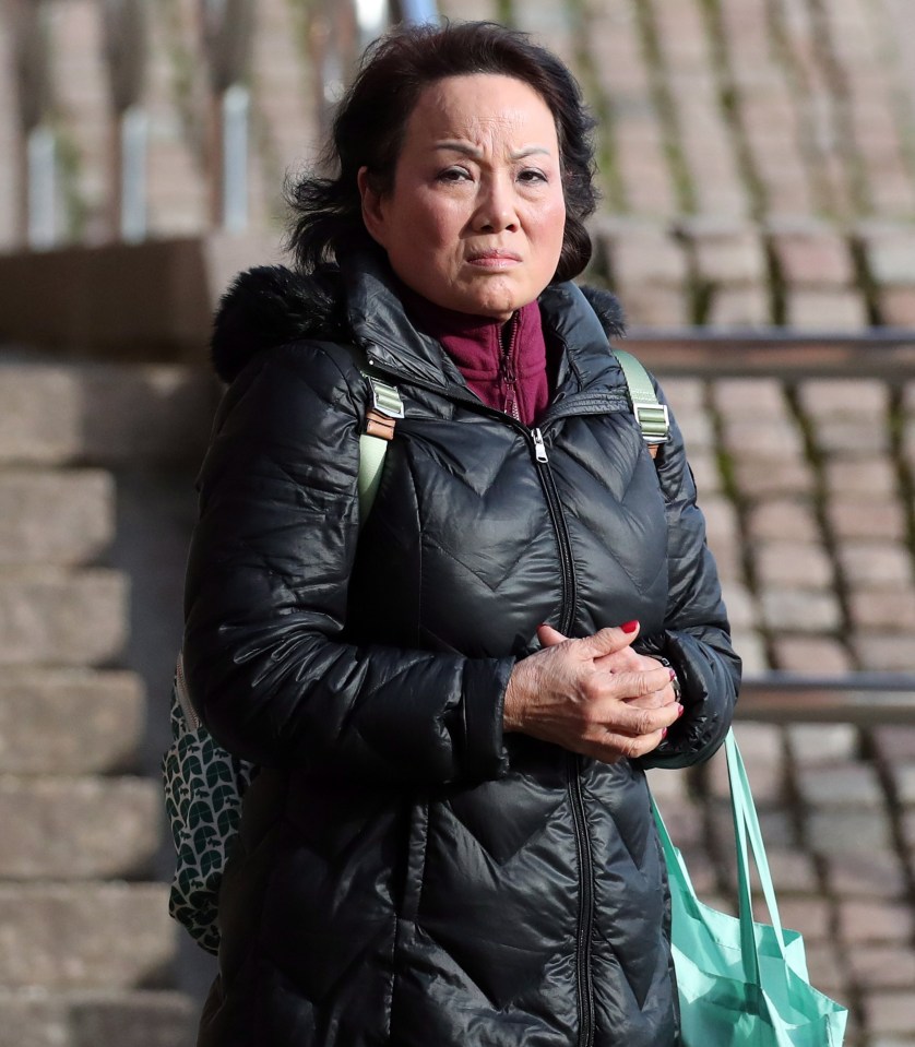 a woman wearing a black jacket and carrying a green bag with the words north on the bottom