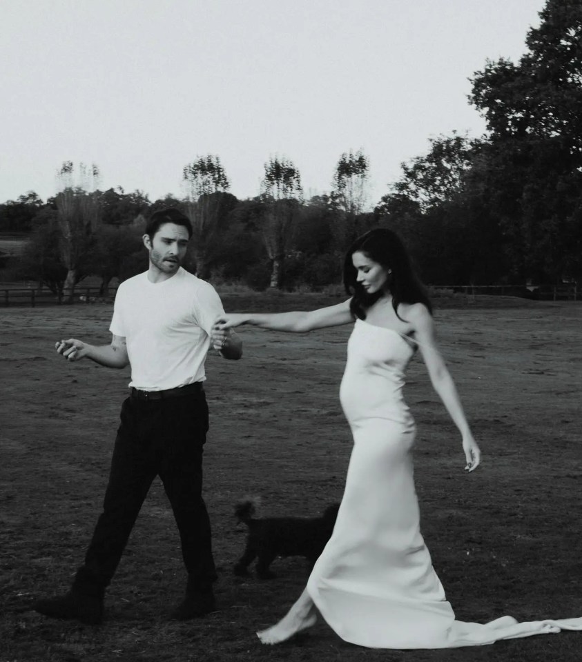 a man and a woman holding hands in a field