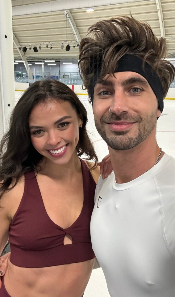 a man and a woman posing for a picture with the man wearing a headband with the letter e on it