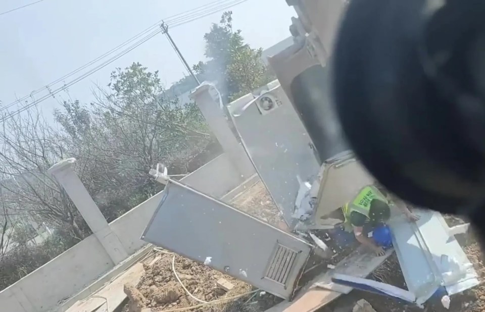 The shocking moment a digger tore apart a portaloo while someone was inside has been caught on camera