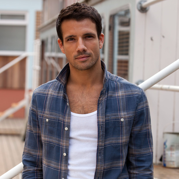 a man wearing a plaid shirt and a white tank top