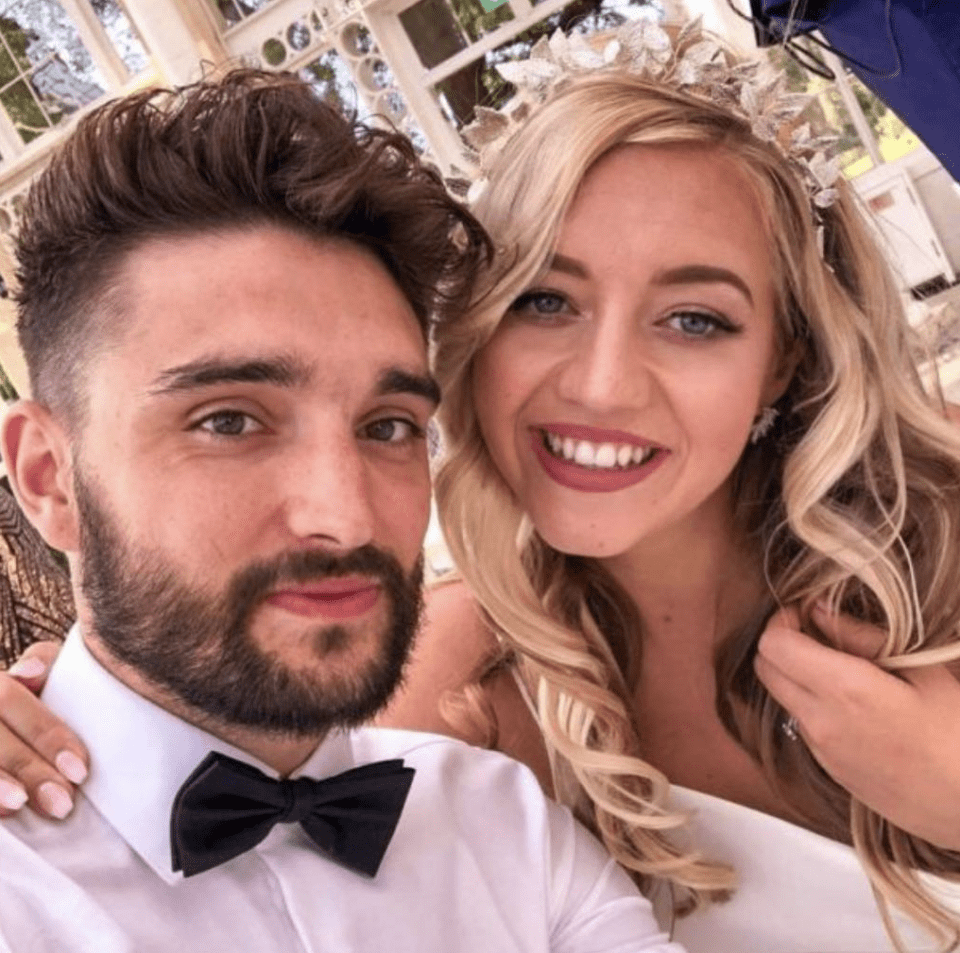 a man and woman pose for a picture and the woman is wearing a tiara