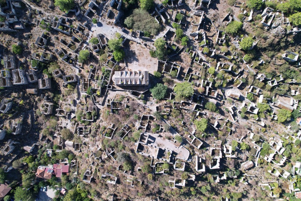 an aerial view of a cemetery with a church in the middle