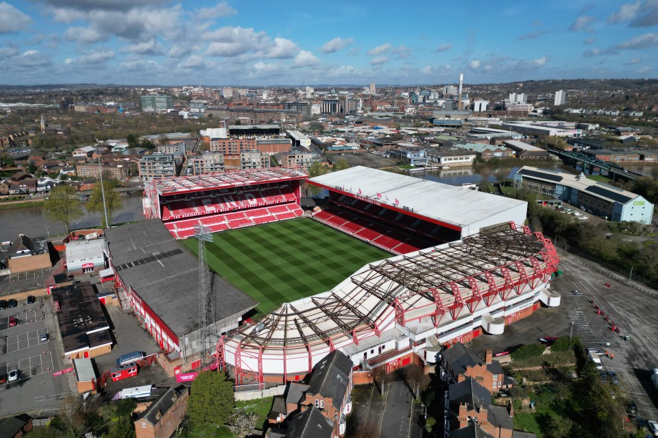 an aerial view of a soccer stadium with a red and white roof