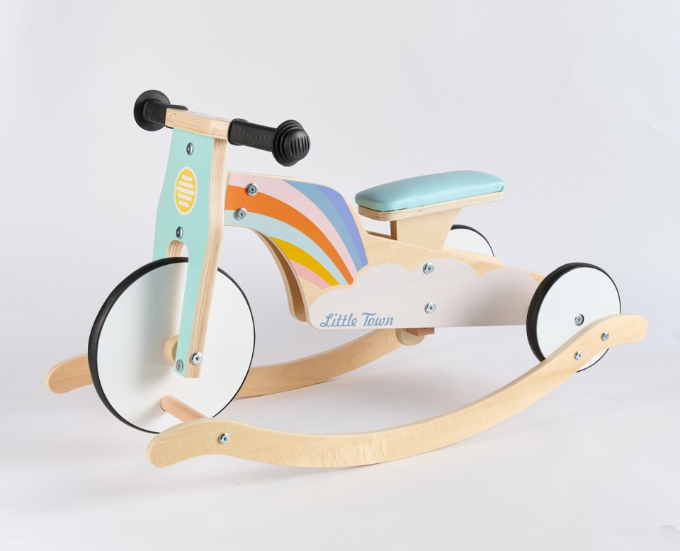 a wooden rocking bike that says little town on it