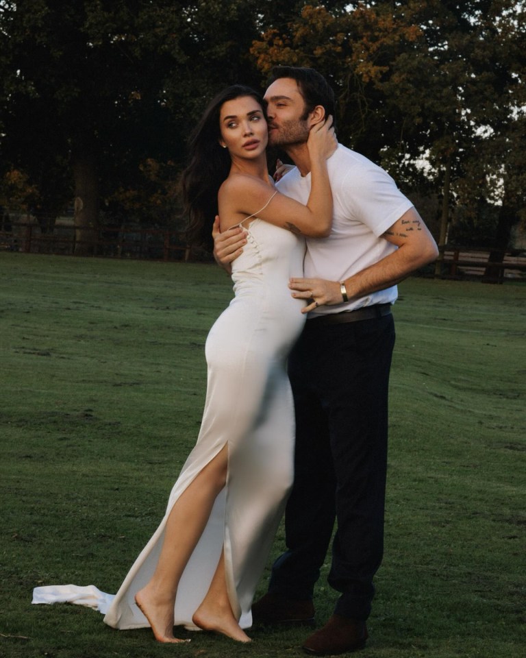 a man kisses a woman on the cheek in a field