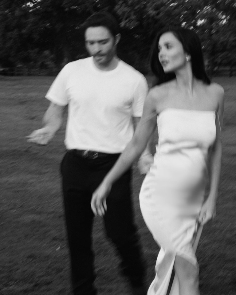 a black and white photo of a man and woman holding hands