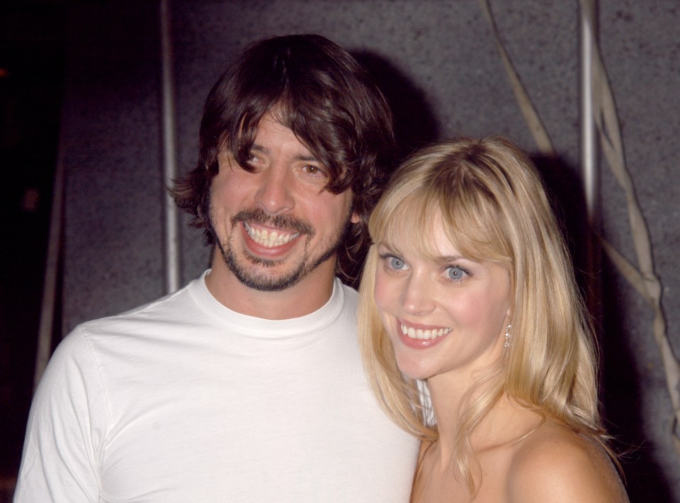 a man with a beard and a woman with blonde hair smile for the camera