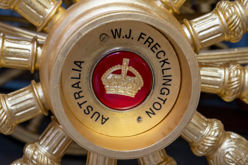 Red wheel hubs embossed with a gold crown logo and Jim's name