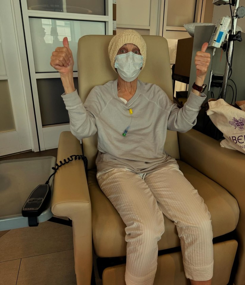 a woman wearing a mask is giving a thumbs up