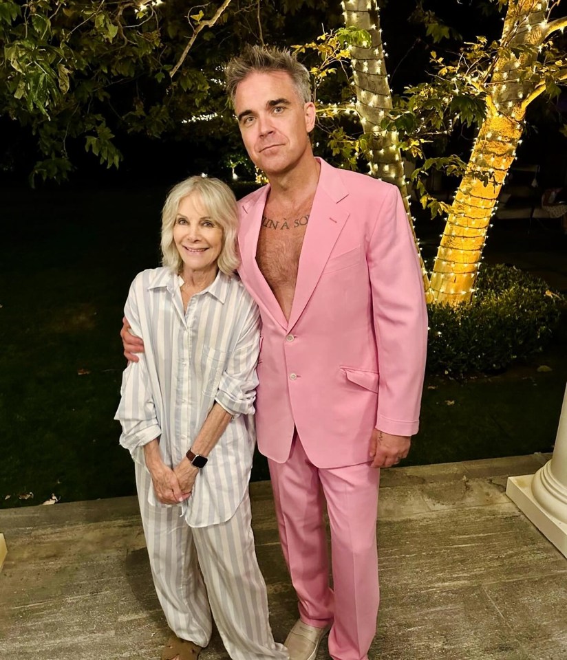 a man in a pink suit is standing next to a woman