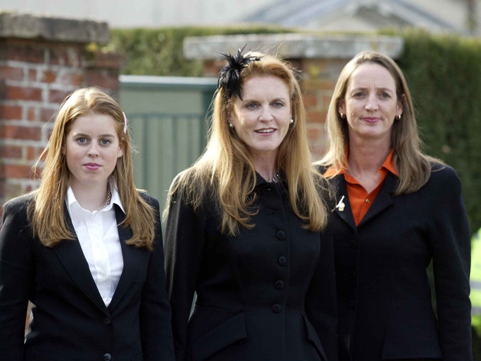 a woman in a black jacket is standing next to two other women