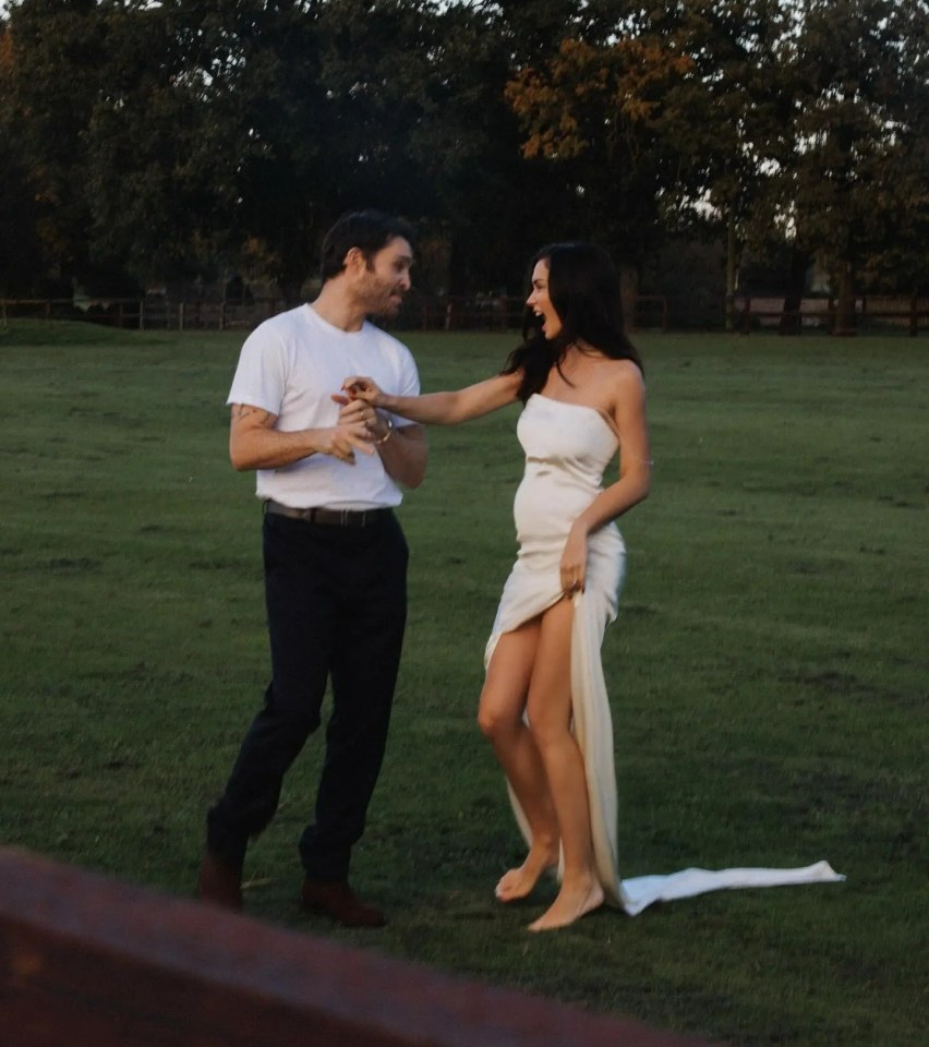 a man and a woman are dancing in a field