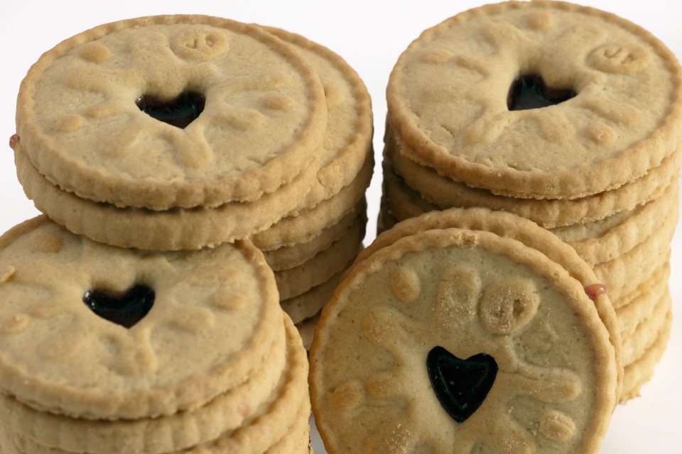 a stack of cookies with a heart shaped hole in the middle