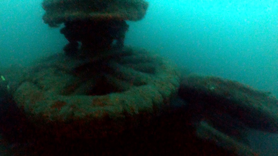 a large rock in the middle of a body of water