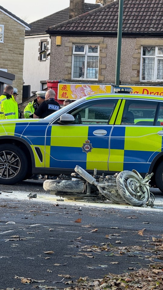 a police car with a motorcycle in front of it