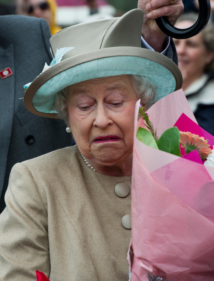 2011: Her Majesty pulls a funny face as flowers are pushed too close to her