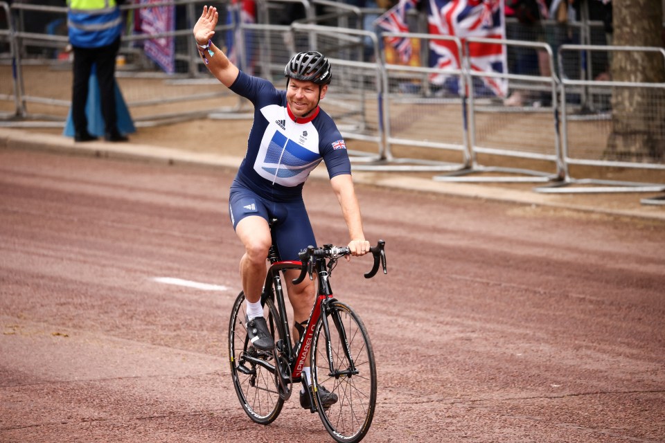 a man riding a bike with a british flag on his shirt