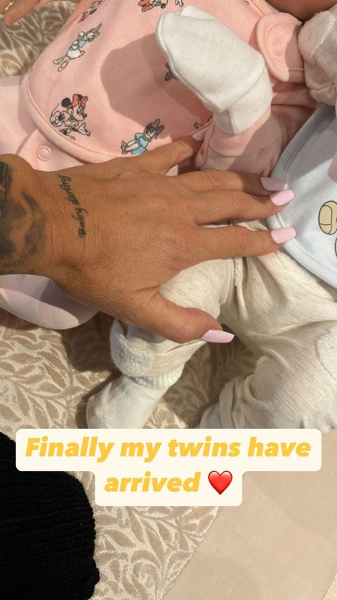 a person holding a baby with the words finally my twins have arrived