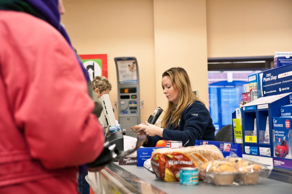 a woman behind a counter with a bag of welcome bread