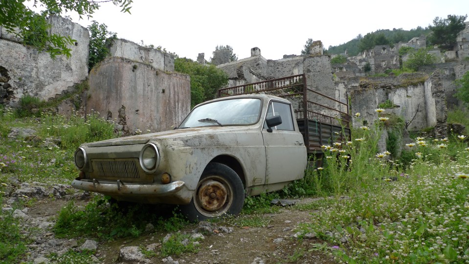 a white truck is parked in a field of flowers