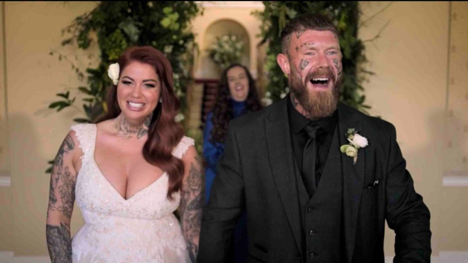 a bride and groom are laughing at their wedding ceremony