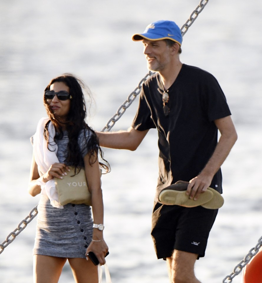 a man and woman are walking in front of a store called brenner