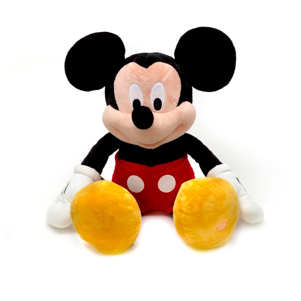 a stuffed mickey mouse is sitting on a white background