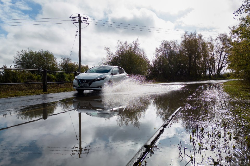 A car on a partially flooded road near Mountsorrel in Leicestershire