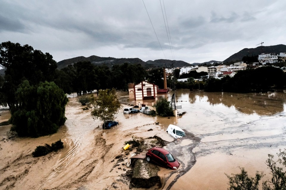 Cars are swept away by the water after rivers burst their banks