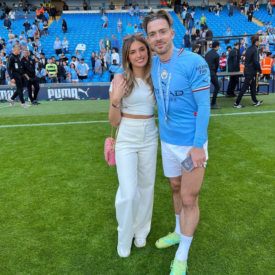 a man in a blue shirt that says etihad stands next to a woman