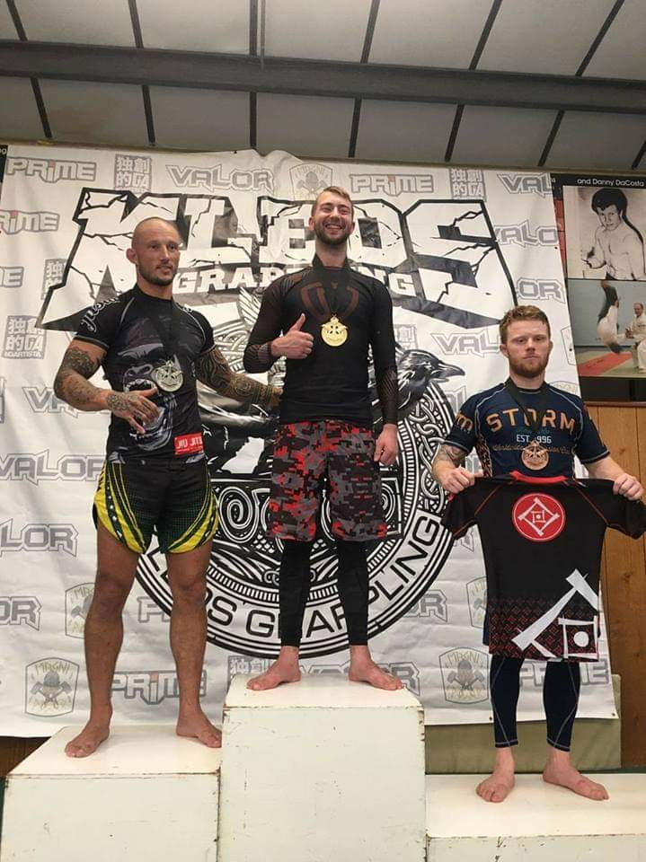 Will Stone (centre) celebrates a Brazilian jiu-jitsu victory