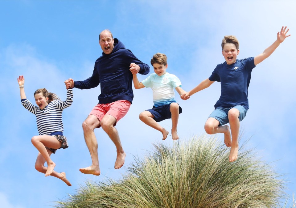 a family is jumping in the air while holding hands