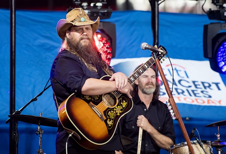 a man playing a guitar in front of a sign that says citi concert series today