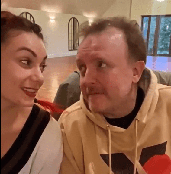 a man and a woman are sitting next to each other and making funny faces .