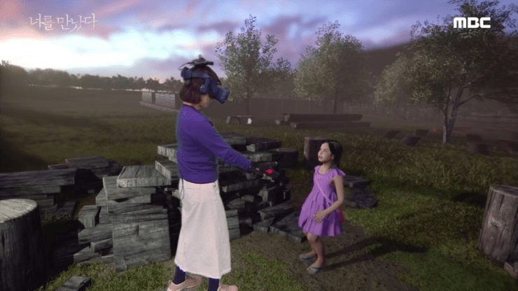 a woman wearing a virtual reality headset talks to a little girl