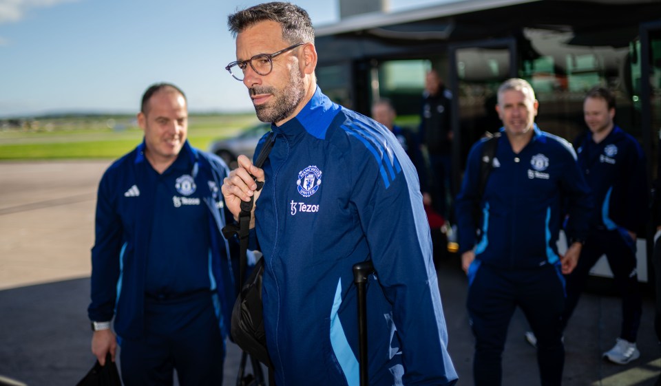 man wearing a blue jacket that says manchester united on it