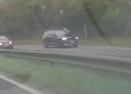 A man was seen desperately clinging to the windscreen