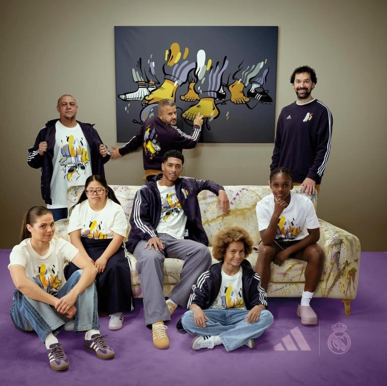 a group of people sitting on a couch wearing adidas shirts