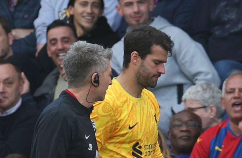 a soccer player is being helped off the field in front of a bet36 sign