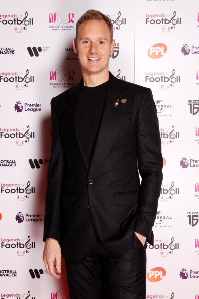 a man stands in front of a red carpet that says legends of football