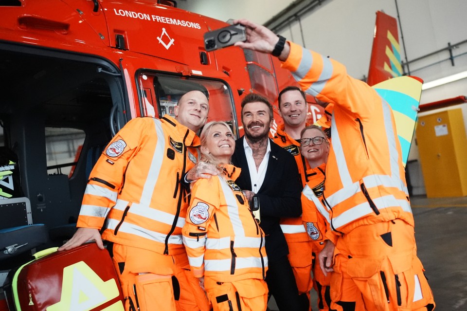 Beckham poses for a selfie with members of the Air Ambulance crew