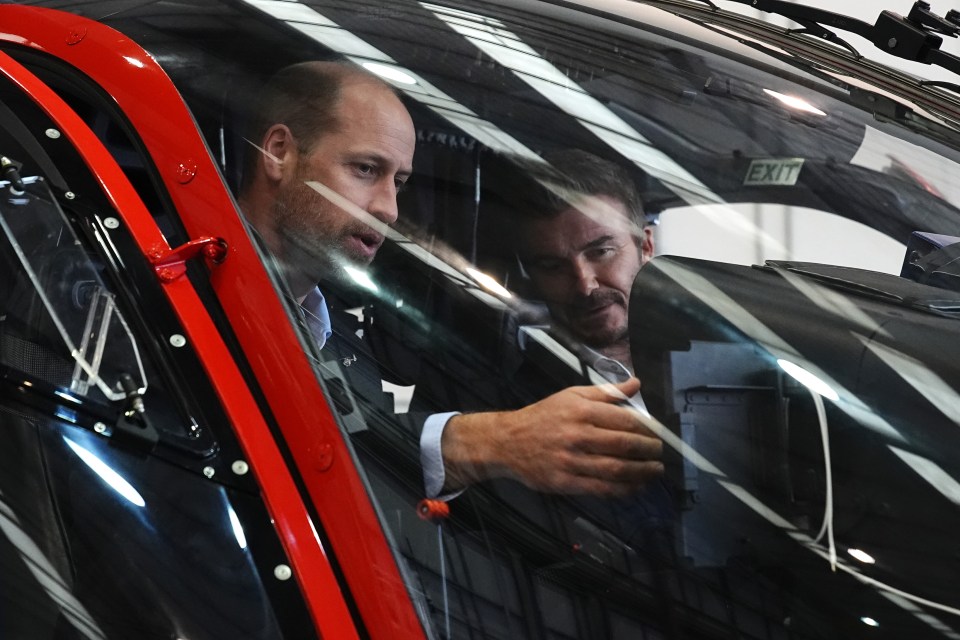 two men in a car with an exit sign on the windshield