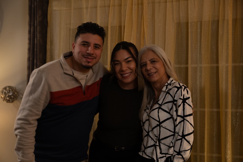 a man and two women pose for a picture together