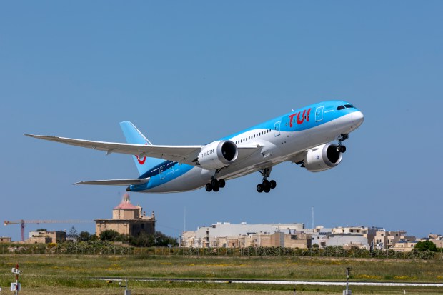 a blue and white airplane with the word tui on the side