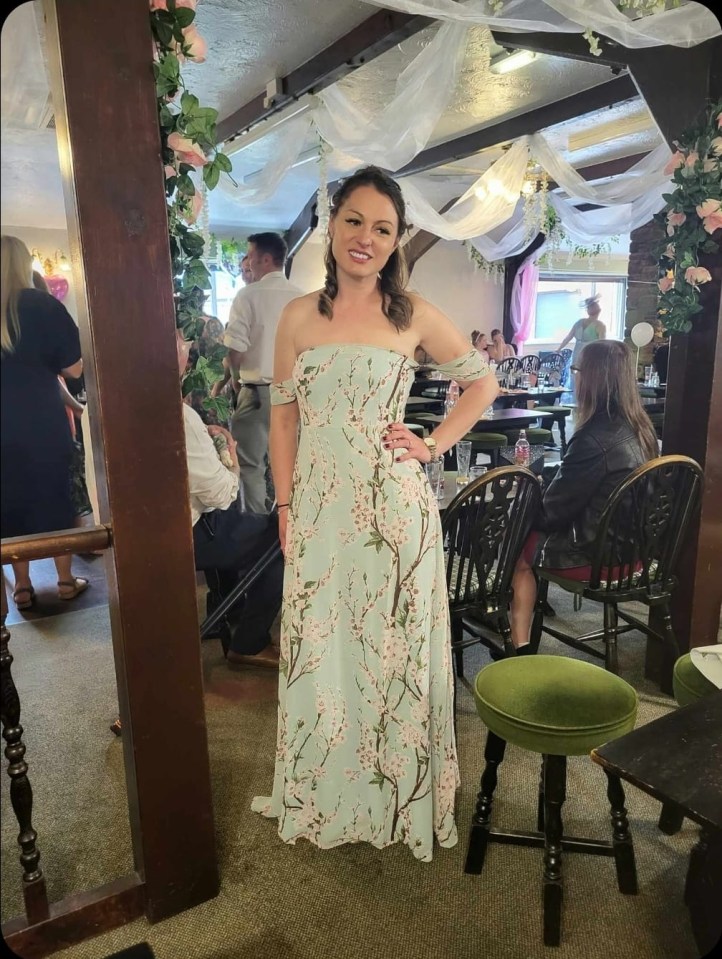 a woman in a floral dress is standing in a room