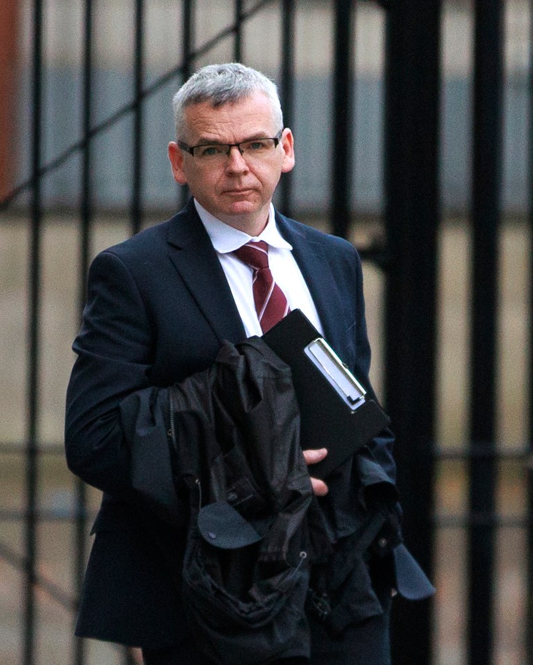 a man in a suit and tie is holding a folder