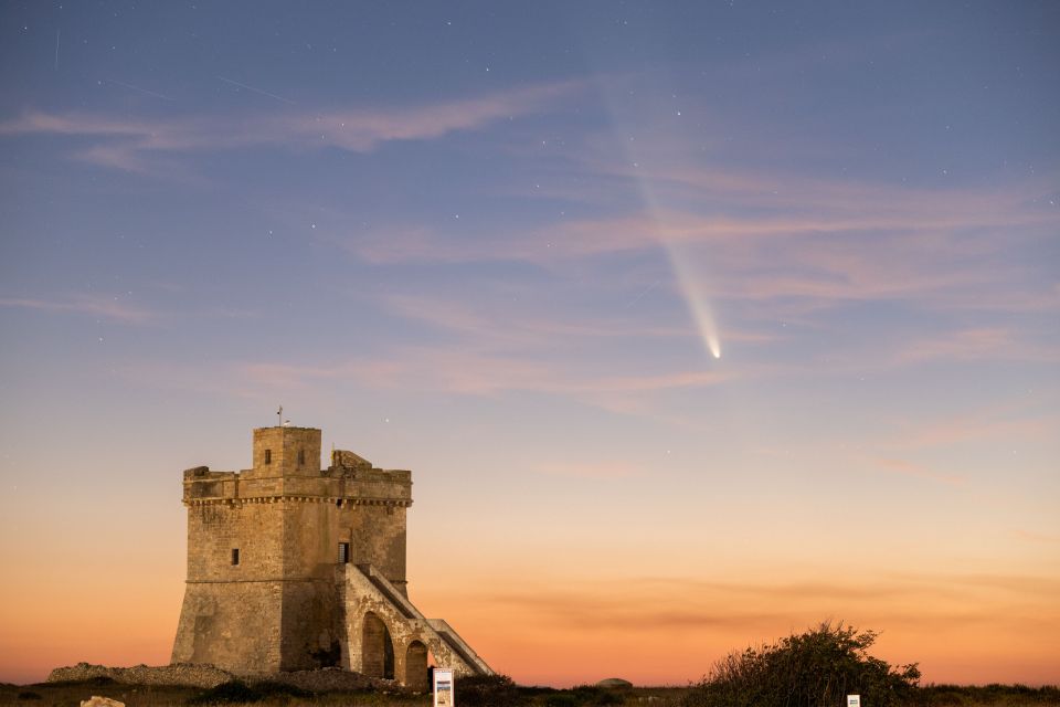 a castle with a comet in the sky above it