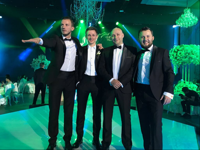 a group of men in tuxedos are posing for a picture