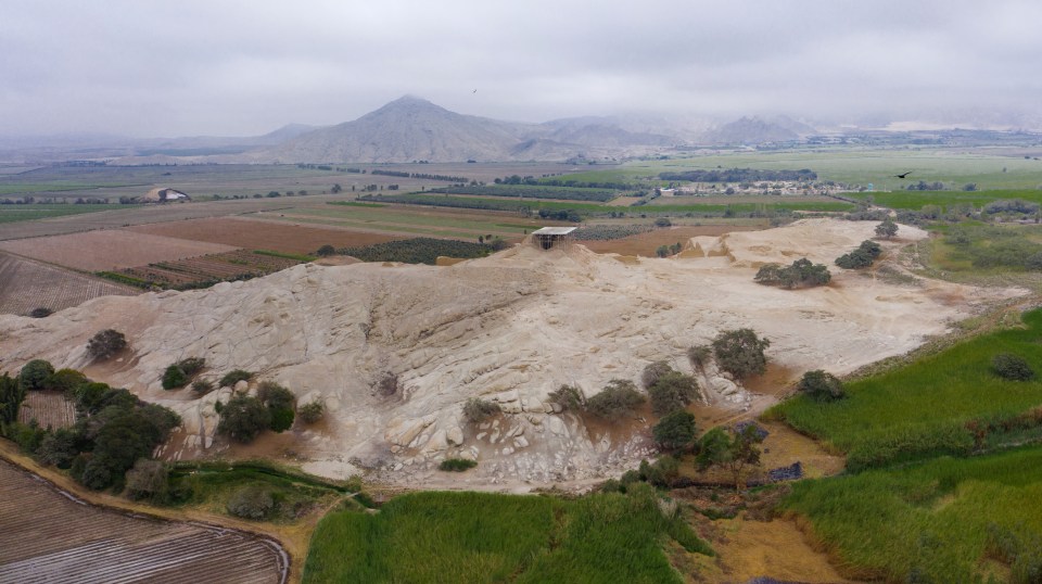 an aerial view of a landscape with mountains in the background